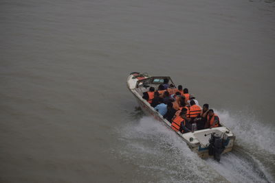 High angle view of people on boat in sea