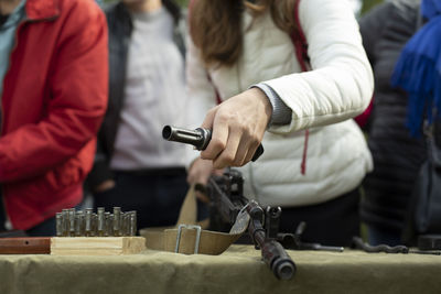 The girl disassembles the kalashnikov assault rifle. military training for schoolchildren. 