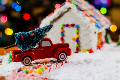 Close-up of multi colored christmas tree in snow