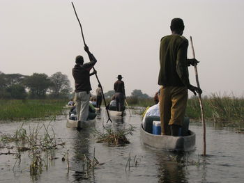 Rear view of couple walking on lake