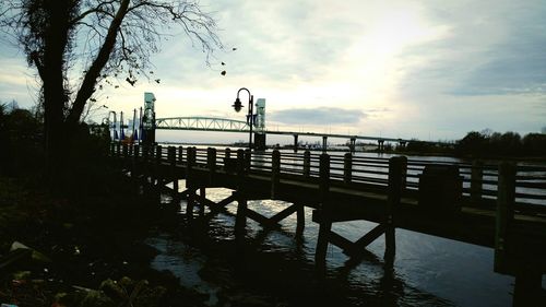 Bridge over river at sunset