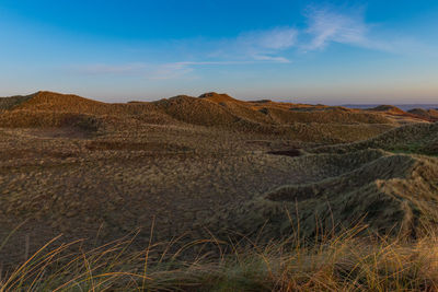 Scenic view of arid landscape against sky