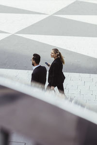 High angle view of business people walking and talking outdoors