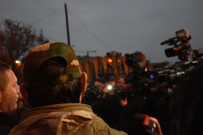 Rear view of man against illuminated city against sky at anti government protests in yerevan armenia