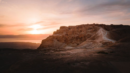 Rock formations against sky during sunset