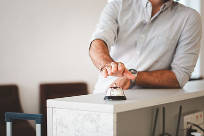 Midsection of man sitting on table