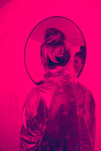 Digital composite image of woman against pink background