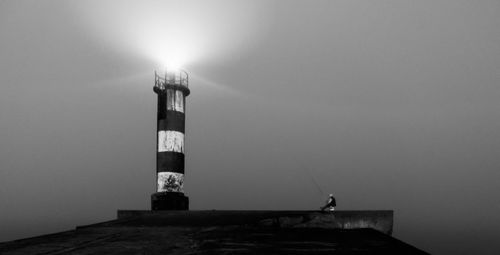 Statue of lighthouse at night