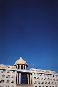 Low angle view of building against clear blue sky