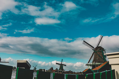 Low angle view of traditional windmill against sky