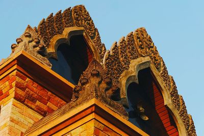 Low angle view of thai architectural feature against sky