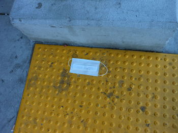 High angle view of yellow mailbox on wall