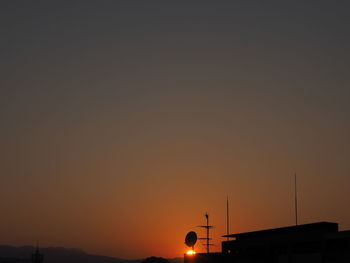 Silhouette of building against sky during sunset