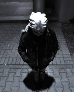 Young woman with umbrella at night