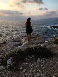 Woman at beach against sky