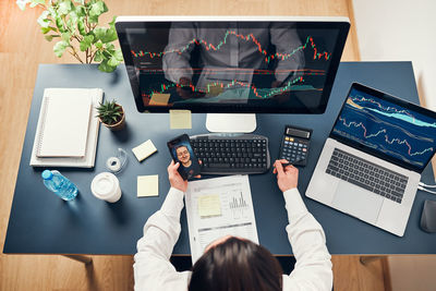 Midsection of businessman working on table