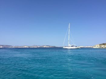 Sailing boat in sea against sky