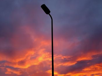 Low angle view of street light against evening sky.