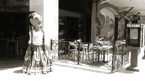 Full length of woman standing by railing