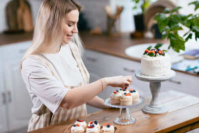 Young woman having food on table