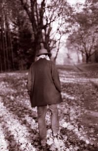 Woman standing on tree trunk