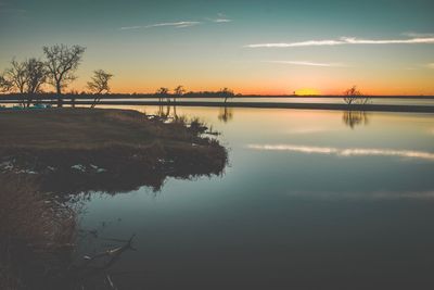 Scenic view of lake against sky during sunset