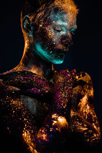 Close-up of statue against black background