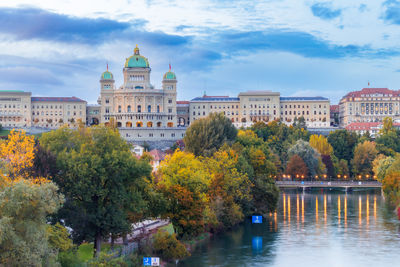 Bridge over river against cloudy sky