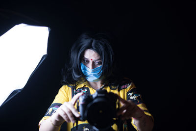 Portrait of woman photographing