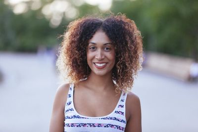 Portrait of smiling young woman with curly hair