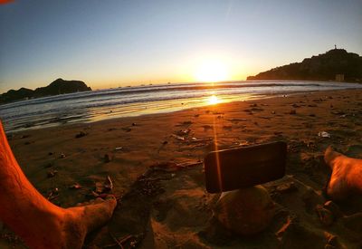 Scenic view of sea against clear sky during sunset