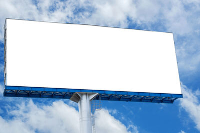 Low angle view of white building against cloudy sky