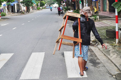 Rear view of women walking on street