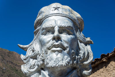 Low angle view of statue against clear blue sky