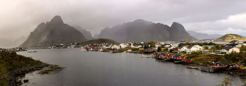 Panoramic view of people by mountains against sky