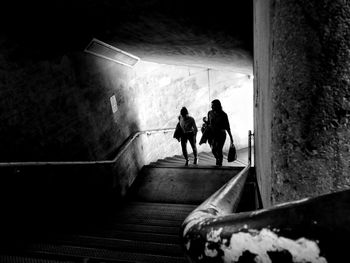 High angle view of female friends on staircase in building