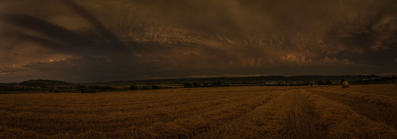 Scenic view of field against sky during sunset