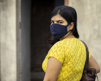 An indian woman in face mask on is going out after unlock 1.0 of corona virus pandemic