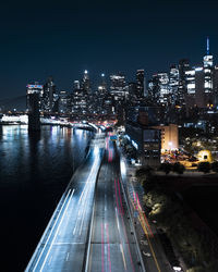 High angle of the highway in new york city at night with the manhattan skyline in the background