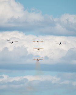 Low angle view of airplane flying against sky