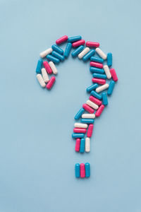 High angle view of pills on white background