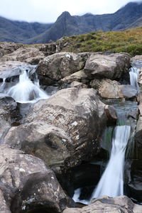 Scenic view of waterfall on rocks