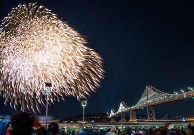 Low angle view of firework display at night