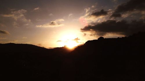 Scenic view of silhouette mountains against sky during sunset