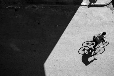 High angle view of man riding bicycle on road