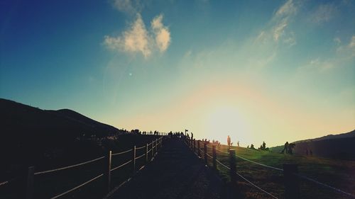 Road amidst mountains against sky during sunset