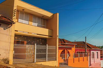 Working-class colored houses and fences in an empty street at são manuel, brazil.