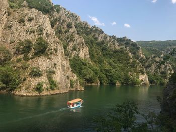 Scenic view of river amidst trees against sky