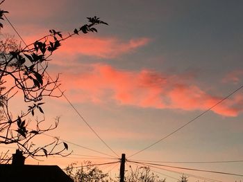 Low angle view of silhouette trees against sky at sunset