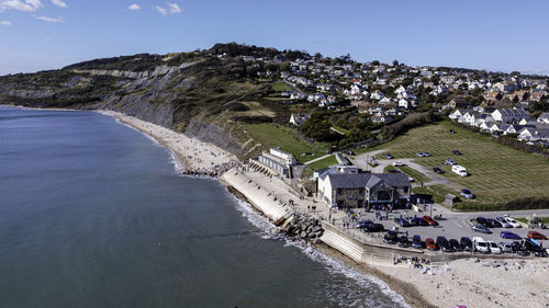 High angle view of buildings by sea against sky